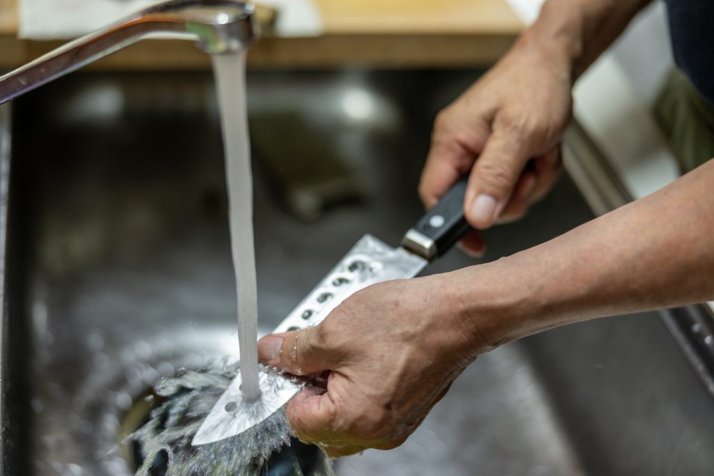 Man's,Hand,Washing,The,Knife,With,Water